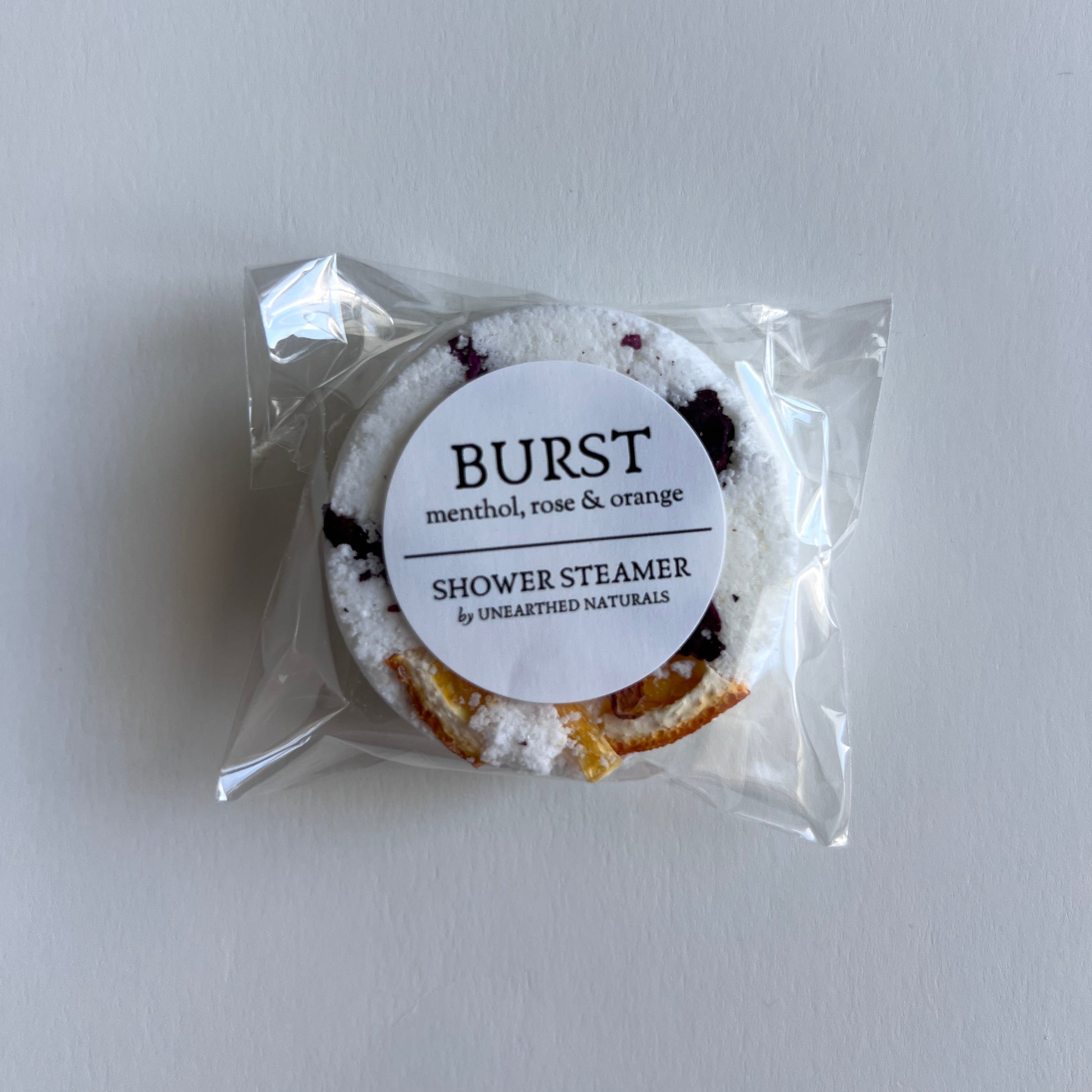 Packaged shower steamer with Burst label on a white background